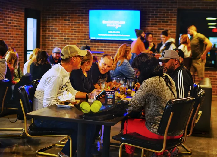 Trivia teams huddled around tables in the taproom