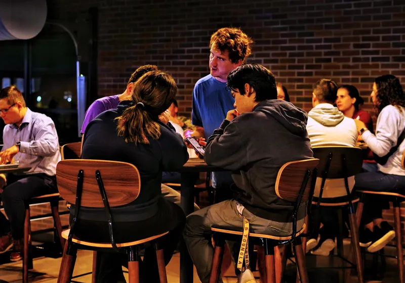 Teams at long tables on the mezzanine during trivia